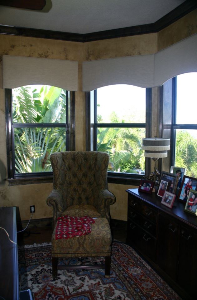 Example of a mid-sized classic freestanding desk dark wood floor study room design in Tampa with beige walls