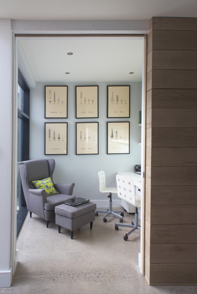 Inspiration for a contemporary home office in Dublin with concrete flooring, a built-in desk and grey walls.