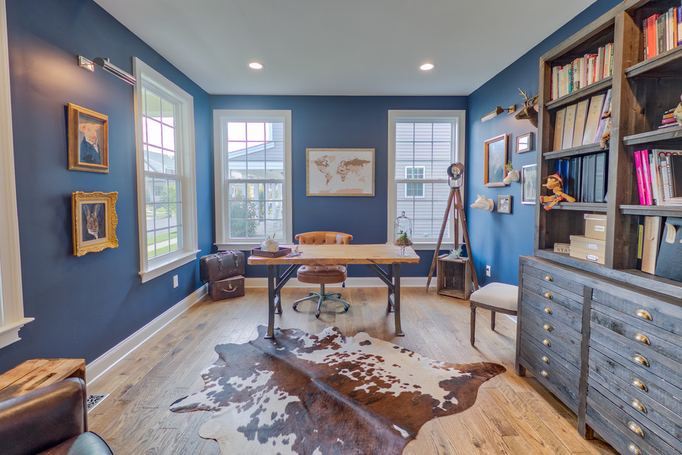 Ejemplo de despacho clásico renovado con paredes azules, suelo de madera en tonos medios, escritorio independiente y suelo marrón