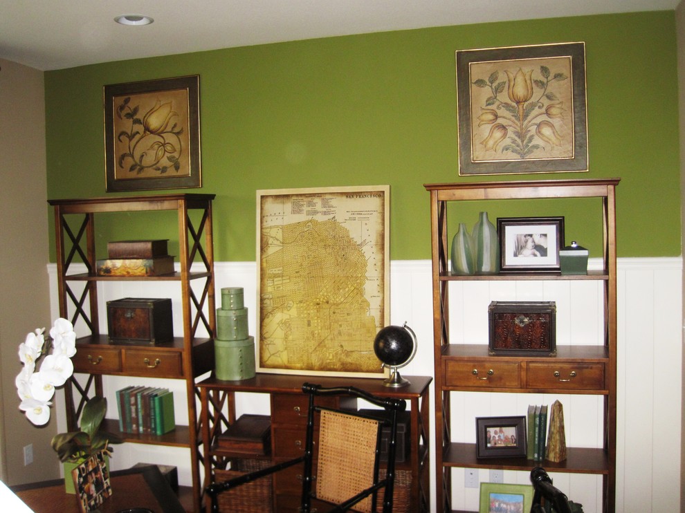 Immagine di uno studio eclettico con pareti verdi e scrivania autoportante