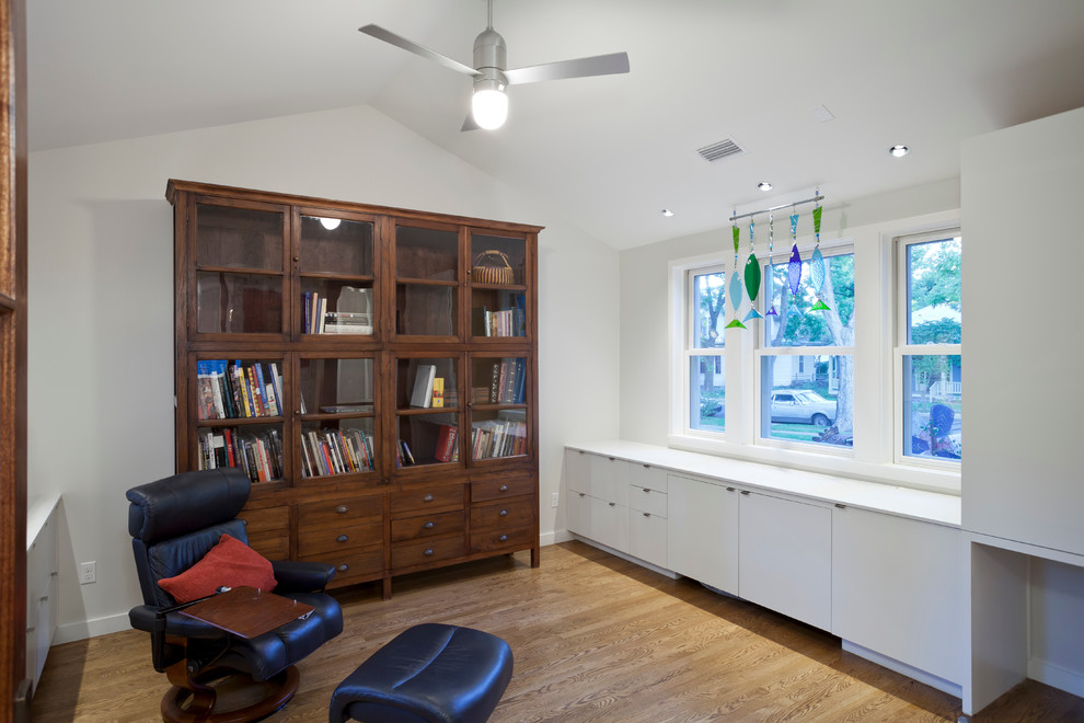 Exemple d'un bureau nature de type studio avec un sol en bois brun, un bureau intégré, un mur blanc, aucune cheminée et un sol marron.