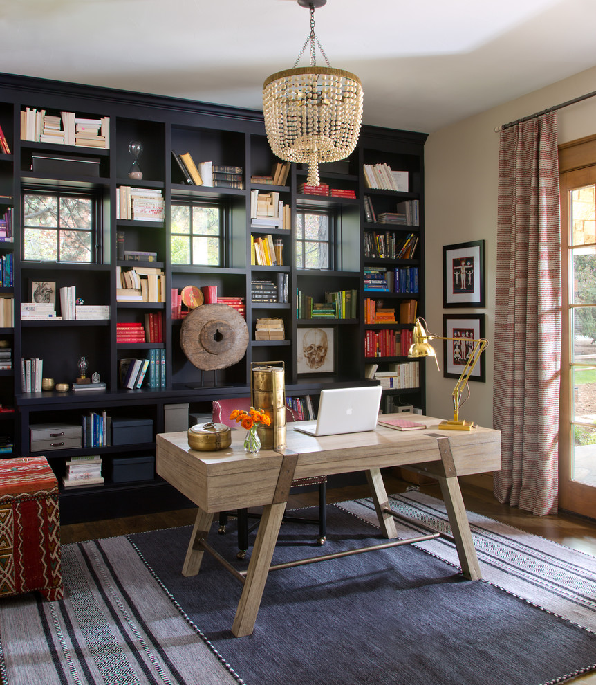 This is an example of an eclectic home office in Denver with yellow walls, dark hardwood flooring, no fireplace and a freestanding desk.