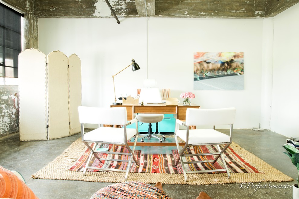 Inspiration for a mid-sized transitional freestanding desk concrete floor home studio remodel in Houston with white walls