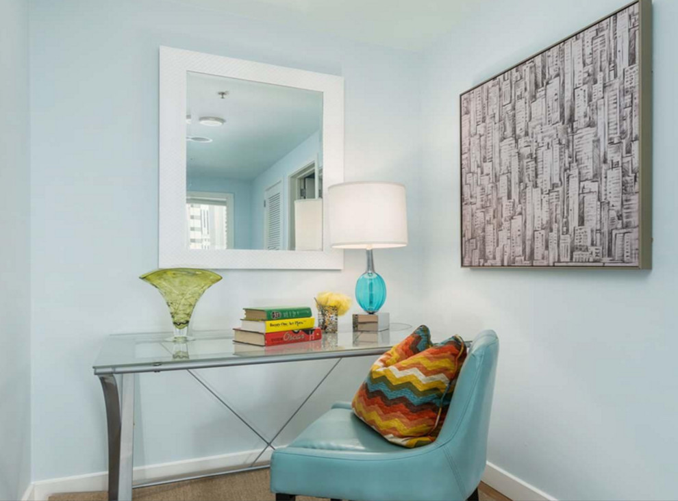 This is an example of a small traditional study in San Francisco with blue walls, carpet, no fireplace, a freestanding desk and beige floors.