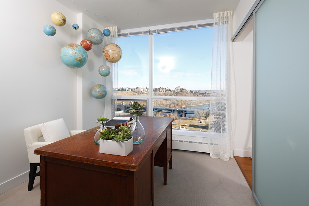 Inspiration for a contemporary home office in Calgary with white walls, carpet and a freestanding desk.