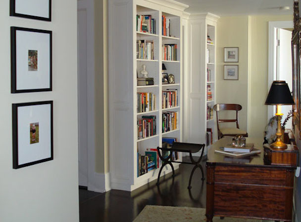 Small classic study in Calgary with beige walls, dark hardwood flooring and a freestanding desk.