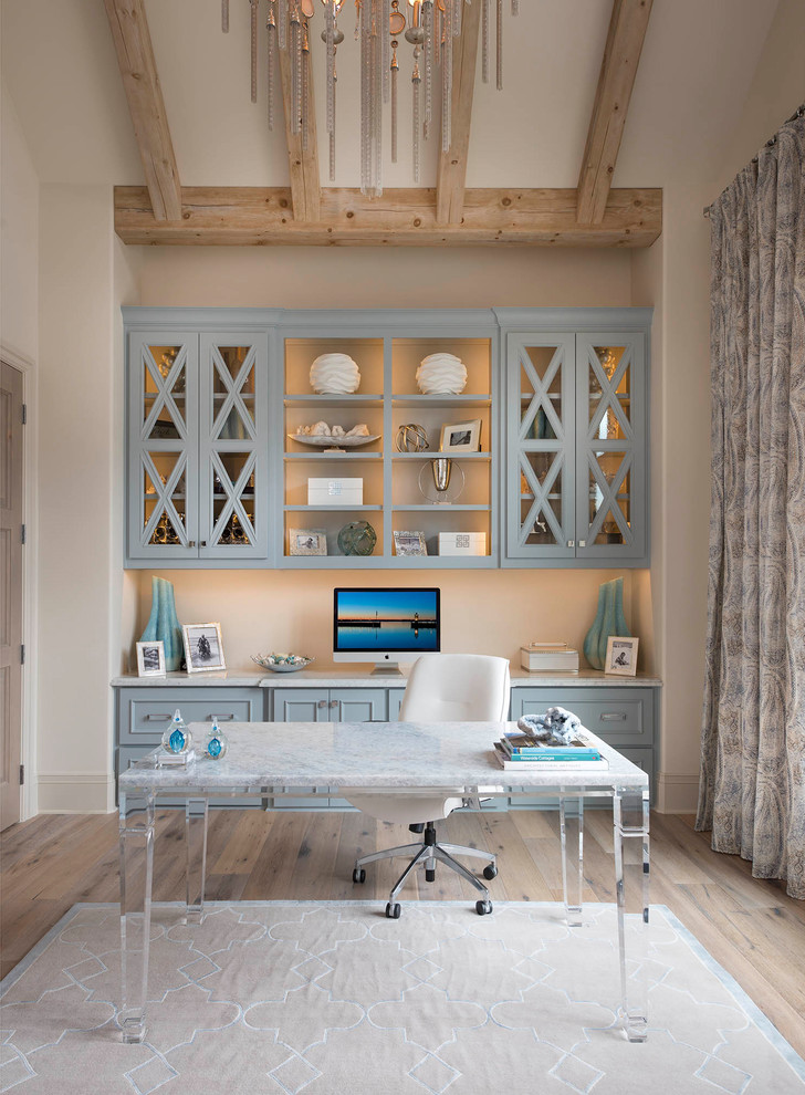 Study room - coastal freestanding desk light wood floor and beige floor study room idea in Dallas with beige walls