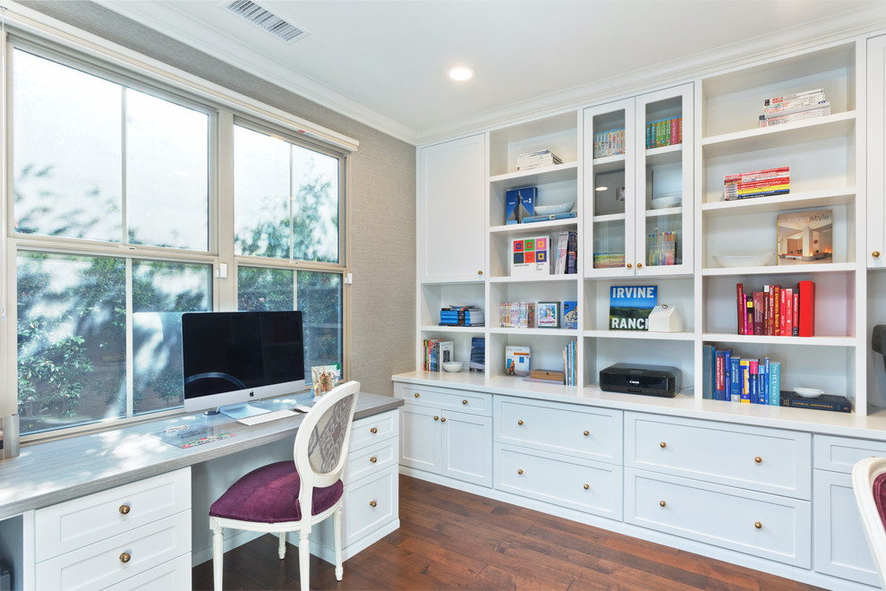Design ideas for a classic home office in Orange County with grey walls, dark hardwood flooring, a built-in desk and brown floors.