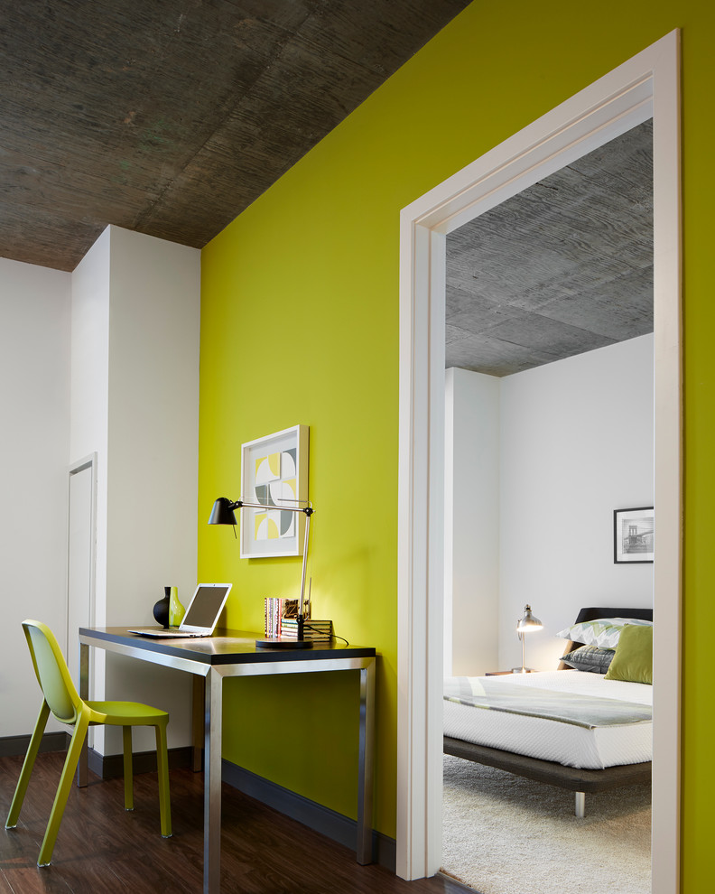 Trendy freestanding desk dark wood floor home office photo in Chicago with green walls