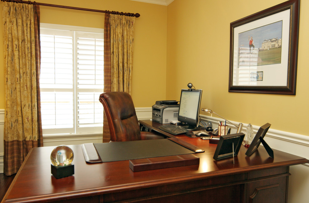 Example of a mid-sized classic freestanding desk home office design in Toronto with yellow walls