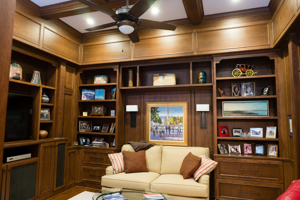 Inspiration for a mid-sized transitional built-in desk medium tone wood floor and brown floor study room remodel in Charlotte with brown walls and no fireplace