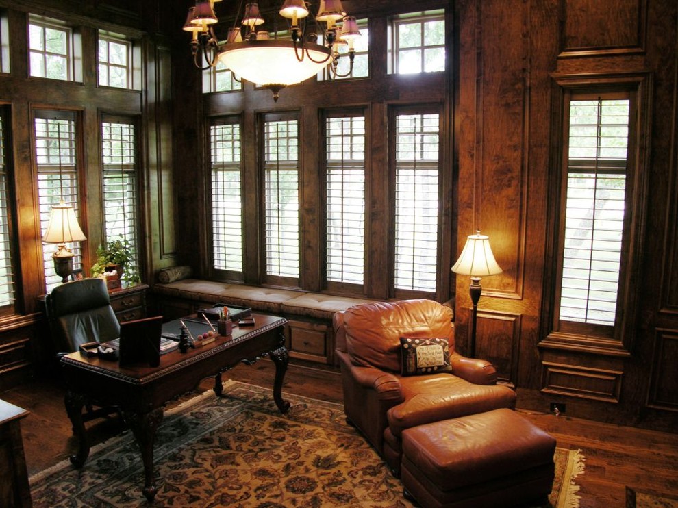 This is an example of a victorian home office in Dallas with dark hardwood flooring and a freestanding desk.