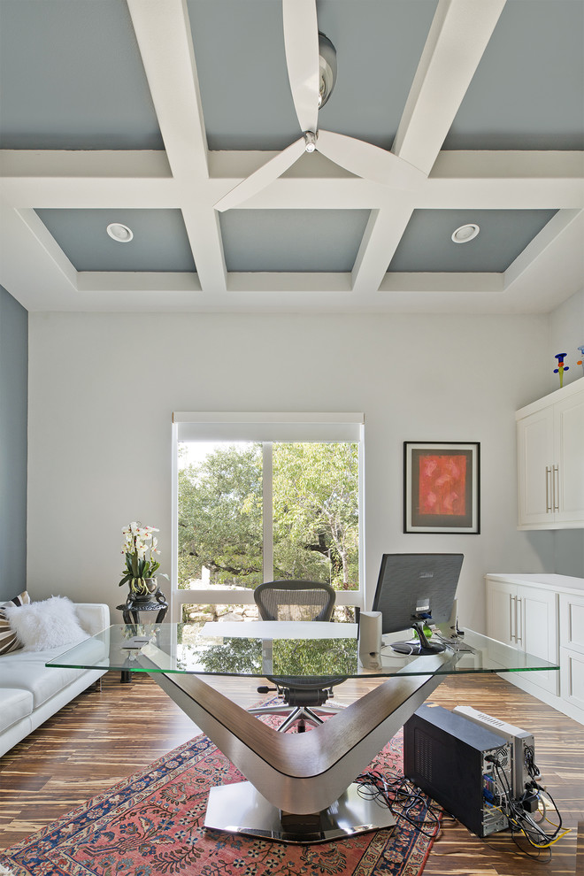 Example of a transitional freestanding desk medium tone wood floor home office design in Austin with white walls