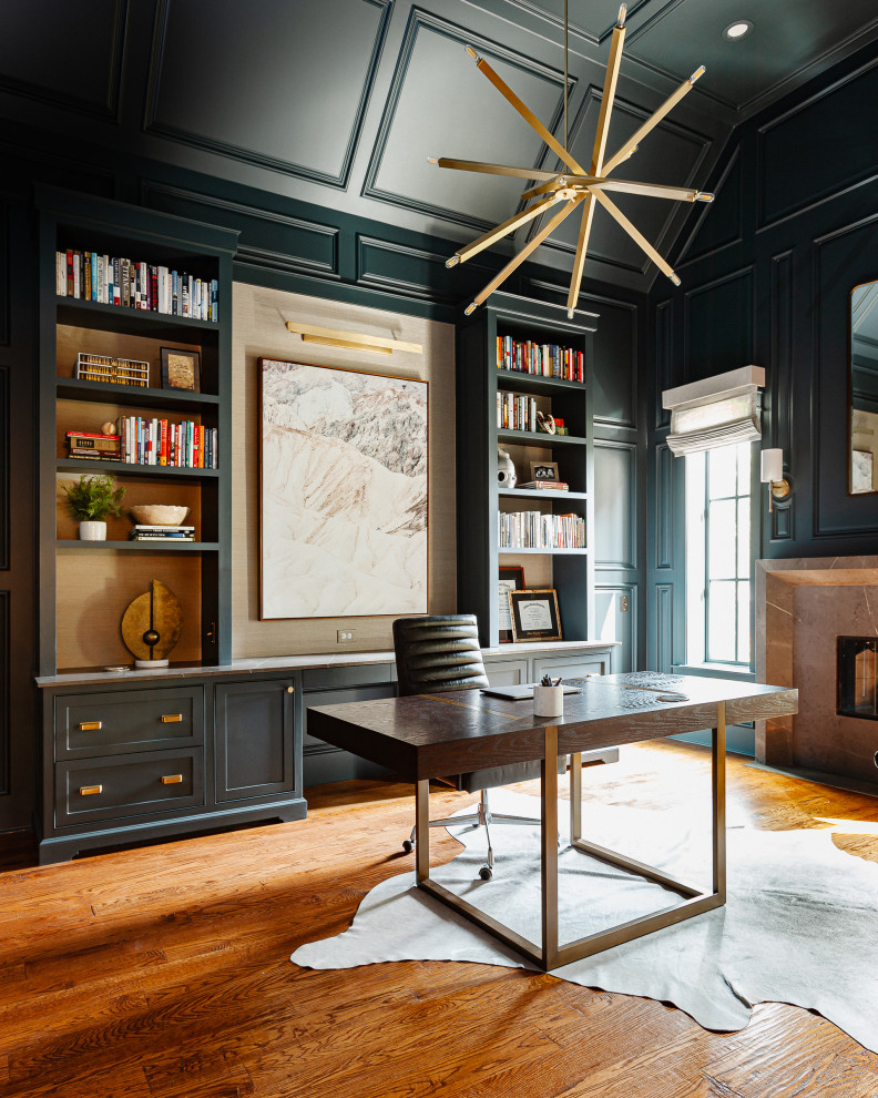 Study room - mid-sized transitional freestanding desk medium tone wood floor, brown floor, vaulted ceiling and wall paneling study room idea in Dallas with green walls, a standard fireplace and a stone fireplace