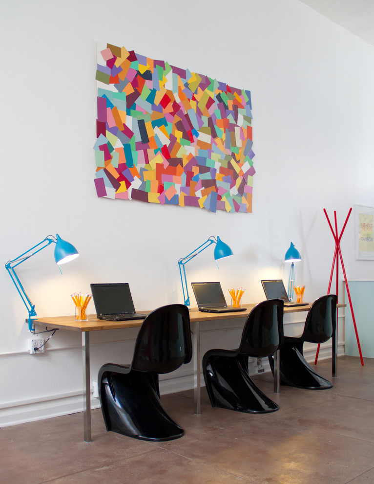 Inspiration for a modern concrete floor home office remodel in Los Angeles with white walls