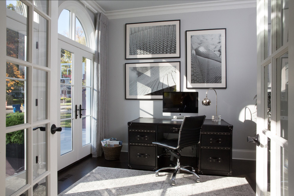 This is an example of a medium sized contemporary study in Chicago with grey walls, dark hardwood flooring, no fireplace and a freestanding desk.