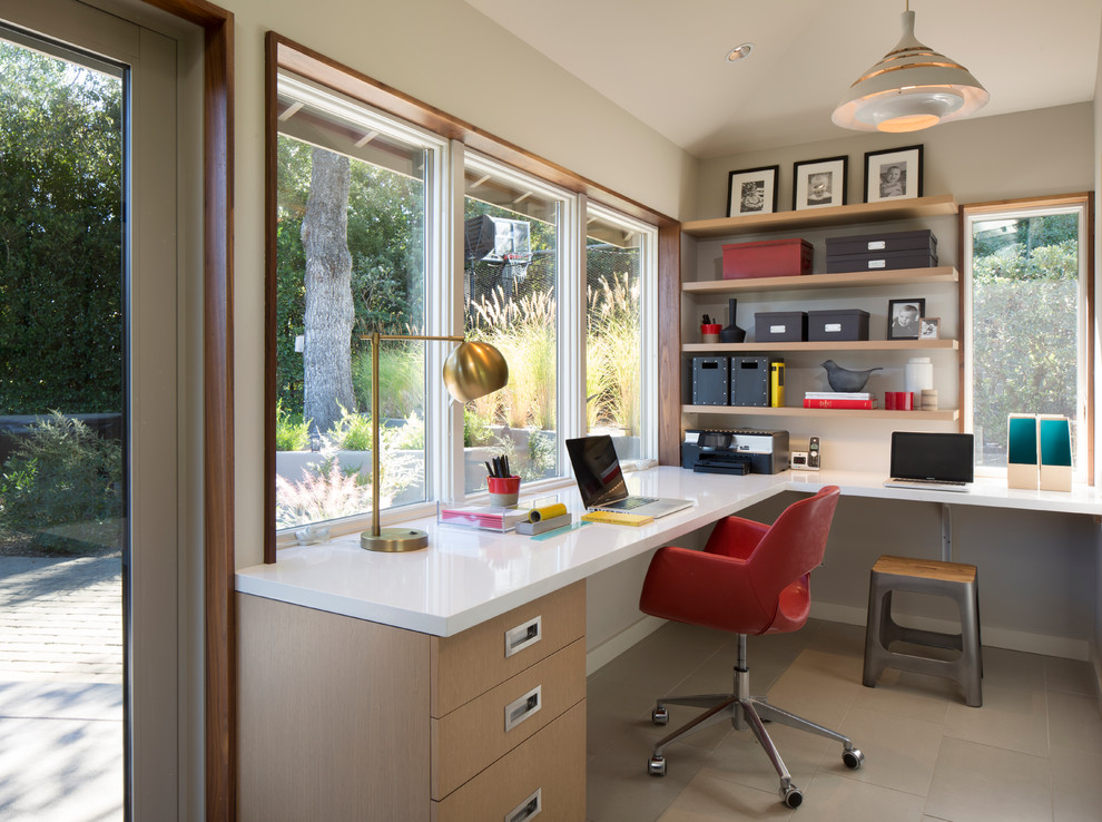 Design ideas for a contemporary home office in San Francisco with white walls, ceramic flooring and a built-in desk.