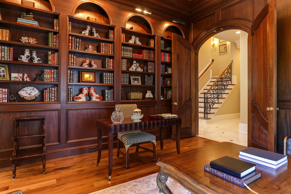 Design ideas for a classic study in Raleigh with brown walls, medium hardwood flooring and a freestanding desk.