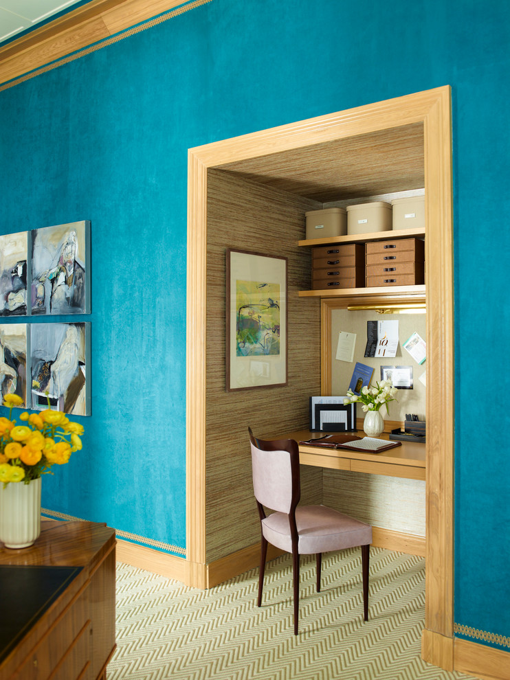 Home office - contemporary built-in desk carpeted home office idea in New York with blue walls