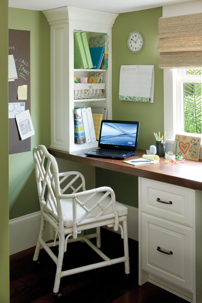 Home office - eclectic built-in desk home office idea in New Orleans with green walls