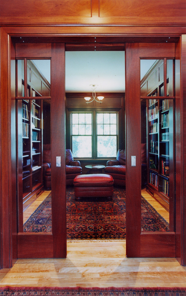 Example of a small classic built-in desk light wood floor home office design in Boston with beige walls