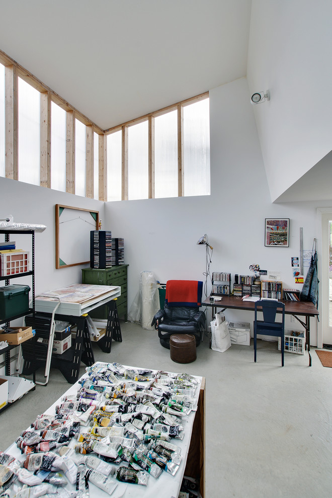 Home studio - small contemporary concrete floor home studio idea in Seattle with white walls