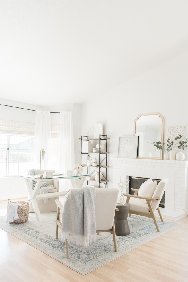 Ejemplo de despacho romántico de tamaño medio con paredes blancas, suelo de madera clara, todas las chimeneas, marco de chimenea de ladrillo, escritorio independiente y suelo beige