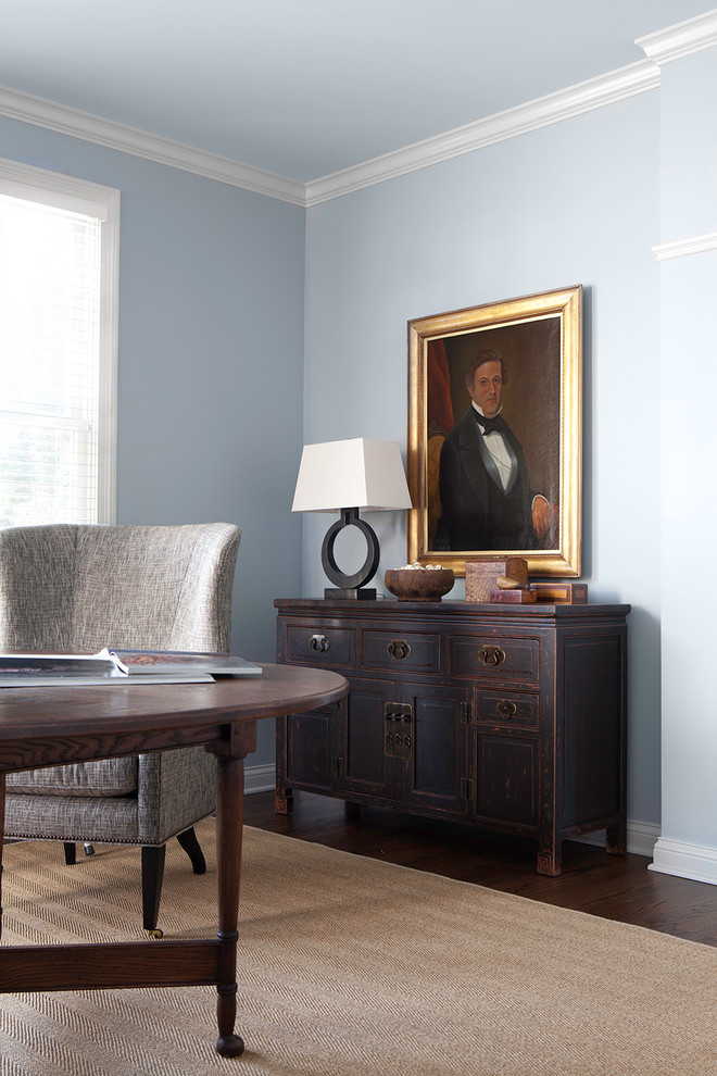 This is an example of a small traditional study in Chicago with blue walls, dark hardwood flooring and a freestanding desk.
