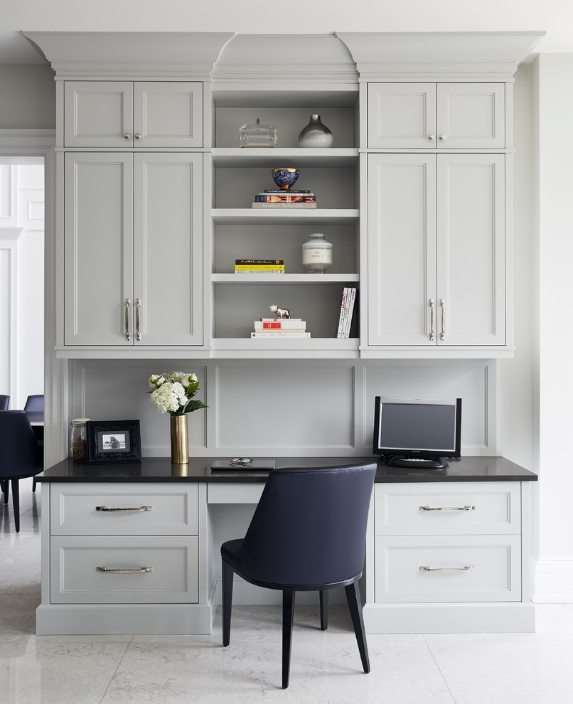 Example of a transitional built-in desk white floor study room design in Toronto
