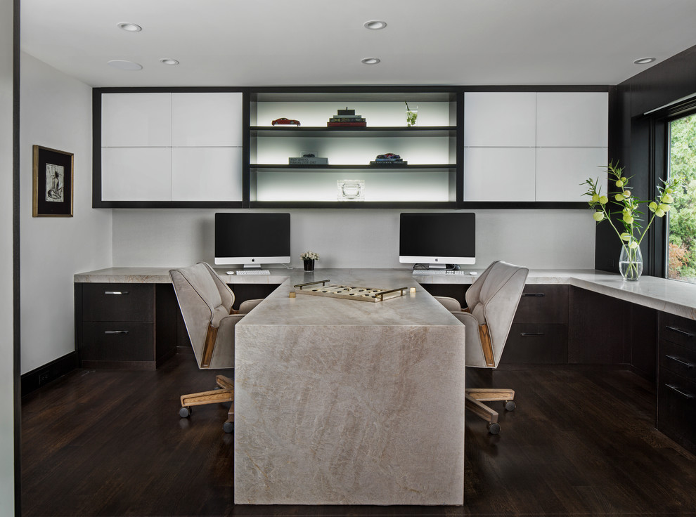 Идея дизайна: кабинет в современном стиле с белыми стенами, темным паркетным полом и встроенным рабочим столом без камина