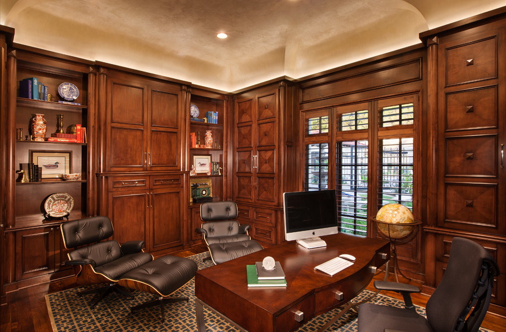Example of a tuscan freestanding desk dark wood floor home office design in Austin