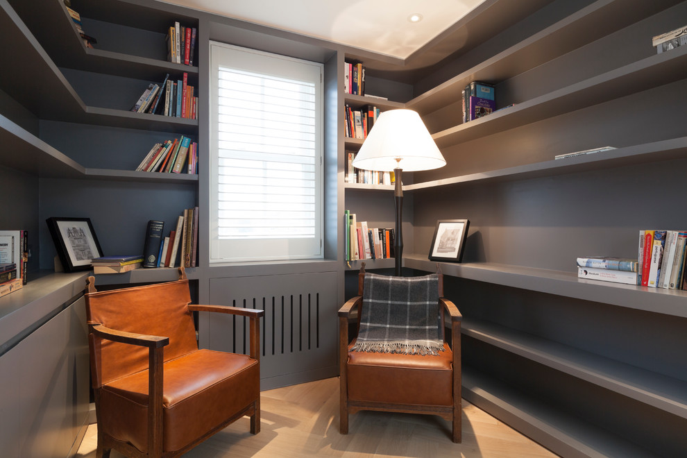 Inspiration for a small modern home office in London with grey walls, medium hardwood flooring and no fireplace.