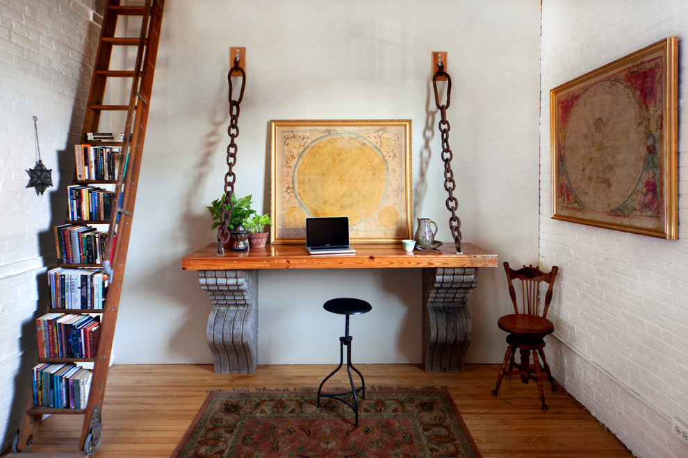 Photo of an industrial home office in Portland Maine with a built-in desk.