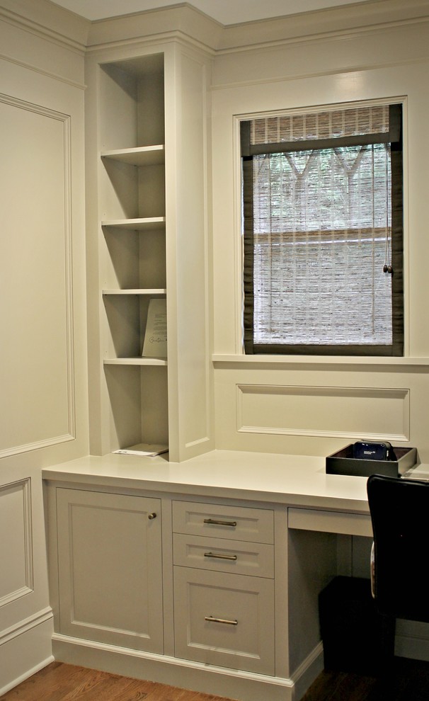Großes Klassisches Arbeitszimmer mit Arbeitsplatz, weißer Wandfarbe, braunem Holzboden, Einbau-Schreibtisch und braunem Boden in New York