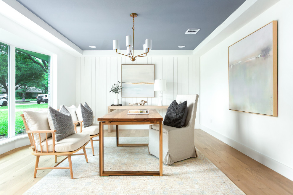 Example of a beach style freestanding desk light wood floor, beige floor, tray ceiling and shiplap wall home office design in Dallas with white walls