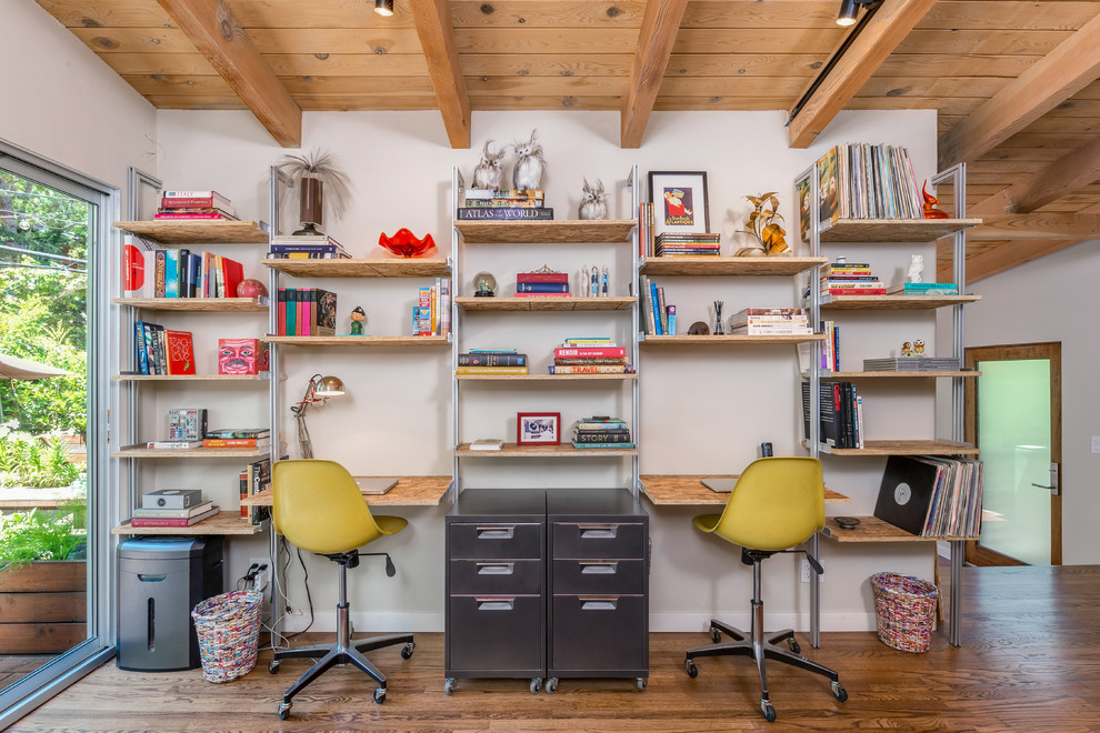 Inspiration for a 1950s built-in desk medium tone wood floor study room remodel in Los Angeles with white walls