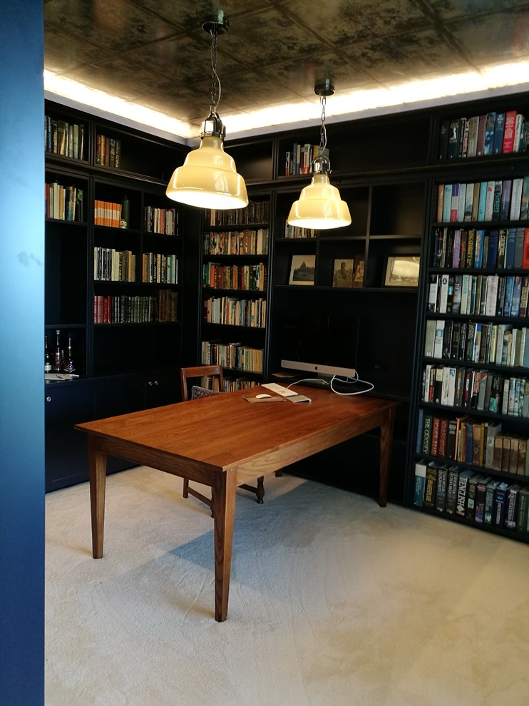На фото: домашняя библиотека среднего размера в стиле неоклассика (современная классика) с синими стенами, ковровым покрытием и отдельно стоящим рабочим столом