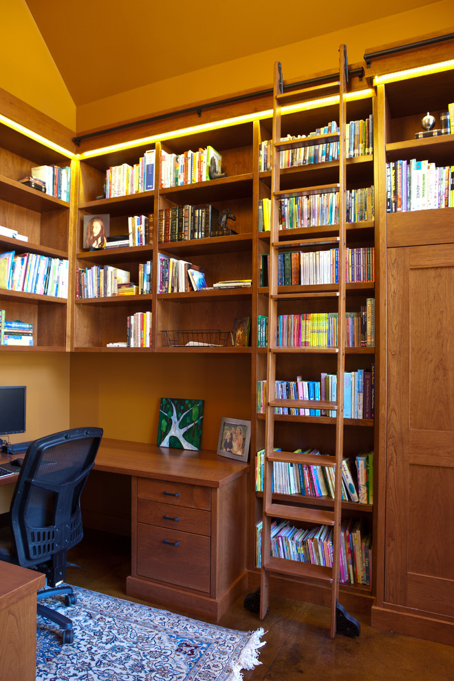 Example of a trendy home office design in Edmonton with orange walls