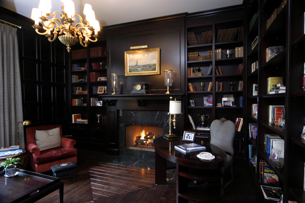 Medium sized classic study in Detroit with medium hardwood flooring, a standard fireplace, a stone fireplace surround and a freestanding desk.