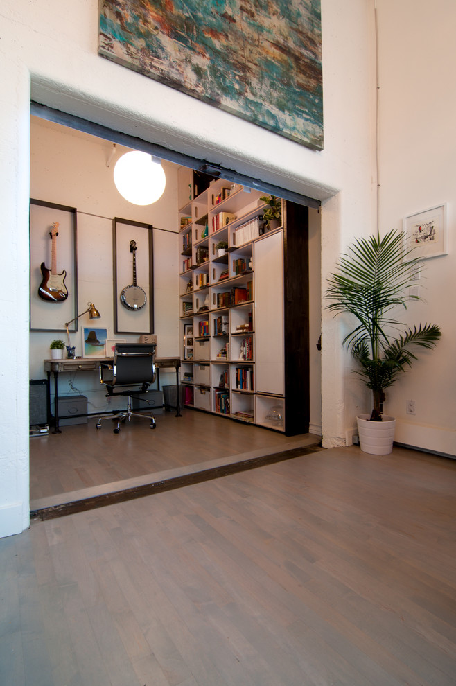 Inspiration pour un petit bureau minimaliste de type studio avec un mur blanc, parquet clair, un bureau indépendant et aucune cheminée.