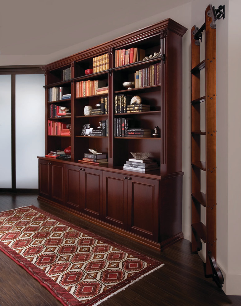 Example of a large classic built-in desk dark wood floor study room design in New York with white walls and no fireplace