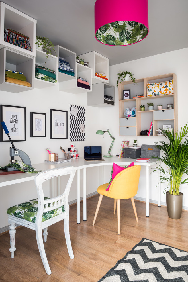 Idéer för mellanstora eklektiska hemmastudior, med vita väggar, laminatgolv, ett fristående skrivbord och brunt golv