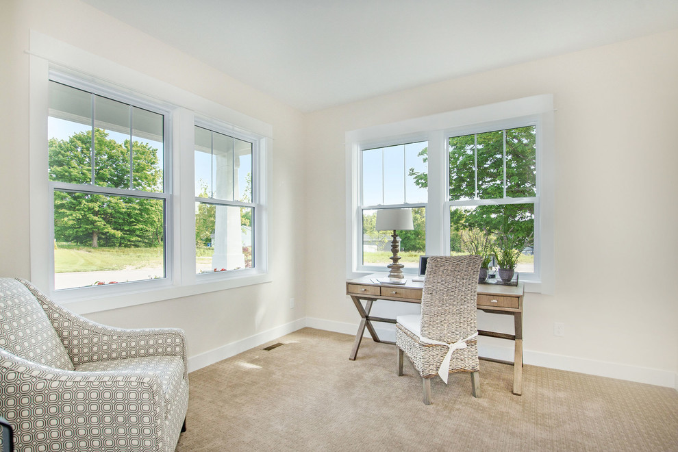 Inspiration for a medium sized traditional home office in Grand Rapids with white walls, carpet, a freestanding desk and beige floors.