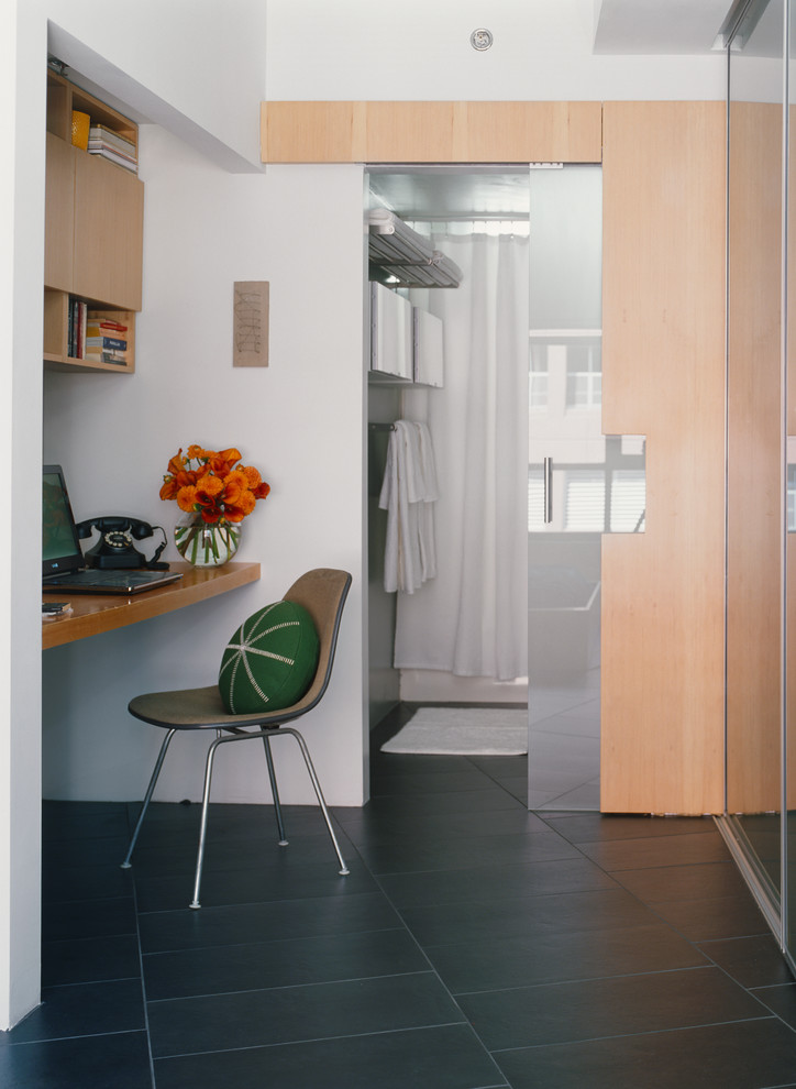Small modern study in Los Angeles with grey walls, a built-in desk and ceramic flooring.