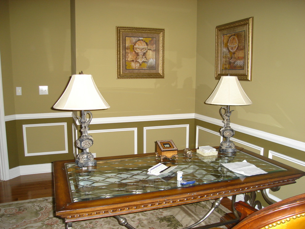 Modelo de estudio de tamaño medio sin chimenea con paredes marrones, suelo de madera en tonos medios y escritorio independiente