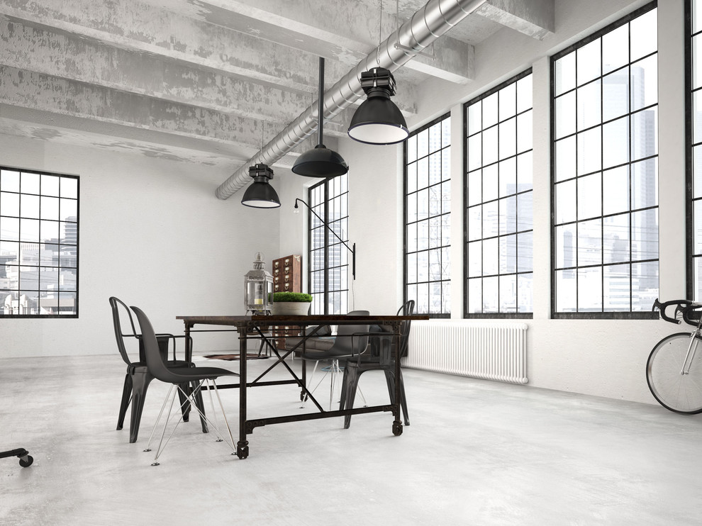 Foto di una grande sala da pranzo industriale con pareti grigie, pavimento in cemento e pavimento grigio