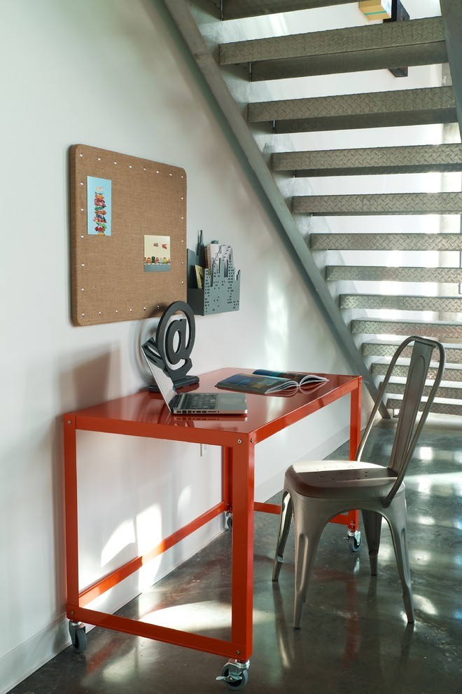 На фото: рабочее место в стиле лофт с белыми стенами, бетонным полом, отдельно стоящим рабочим столом и серым полом без камина с