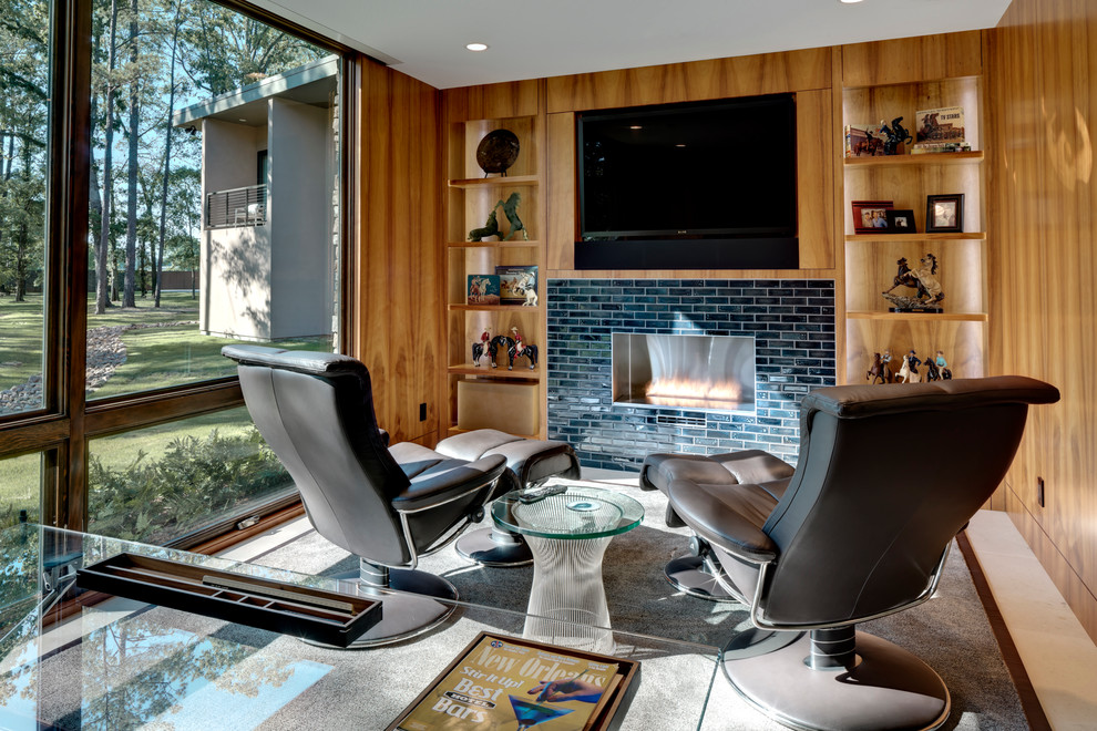 На фото: кабинет в современном стиле с горизонтальным камином, фасадом камина из плитки и отдельно стоящим рабочим столом