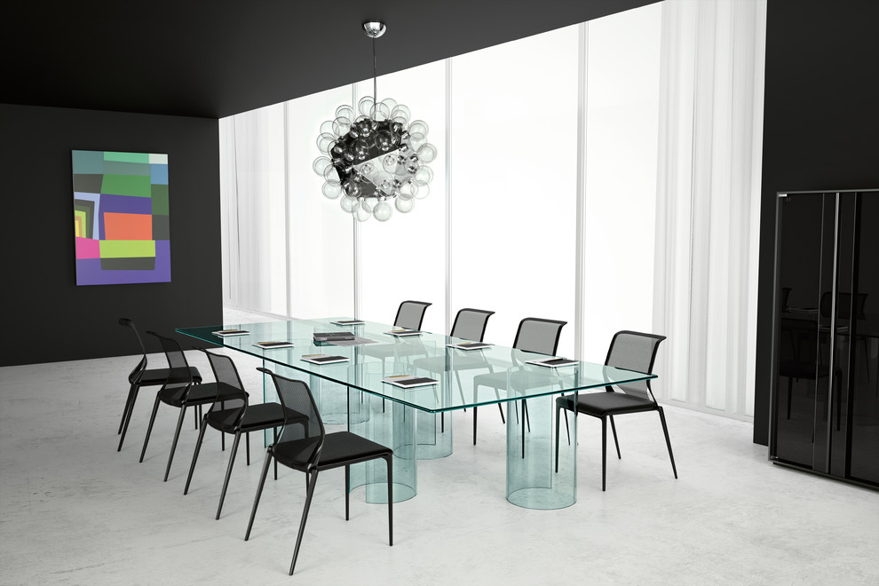 Example of a huge minimalist concrete floor and white floor dining room design in New York with black walls