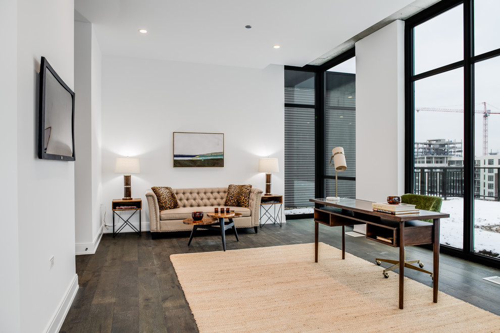 Large contemporary study in Chicago with white walls, medium hardwood flooring, a freestanding desk and brown floors.